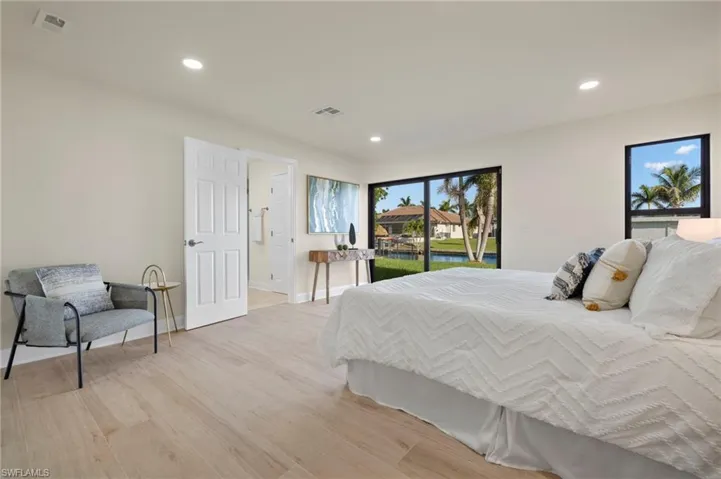 Bedroom with access to outside and light hardwood / wood-style floors