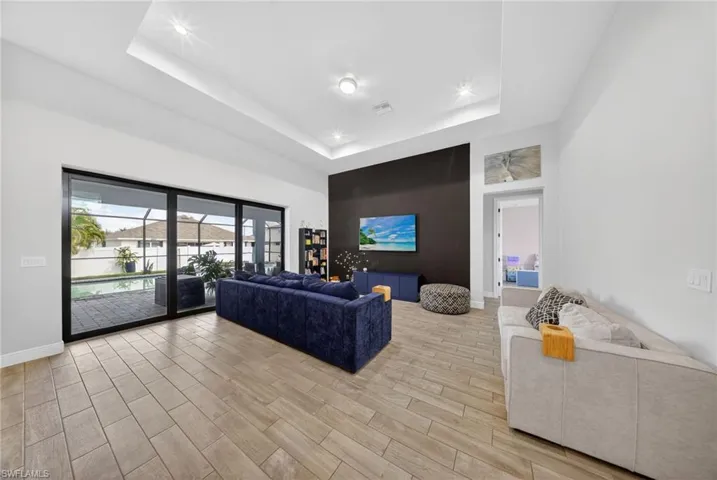 Living room featuring wood finish floors and a tray ceiling
