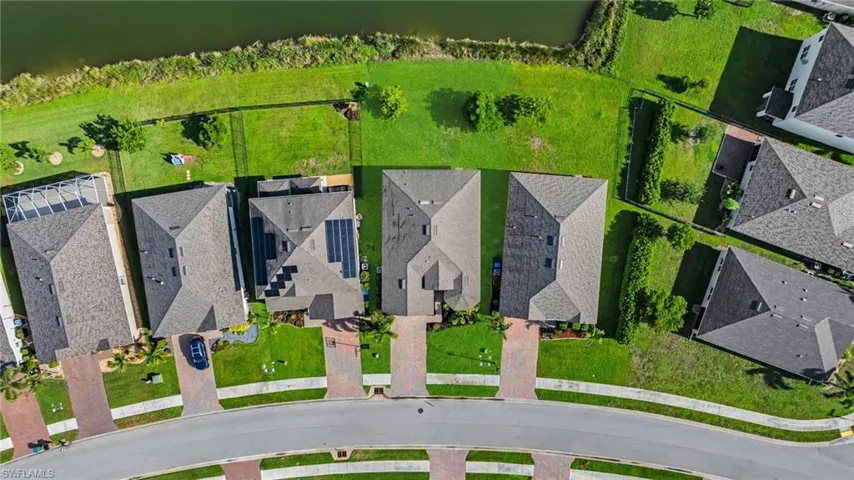 Aerial perspective of suburban area featuring a large body of water