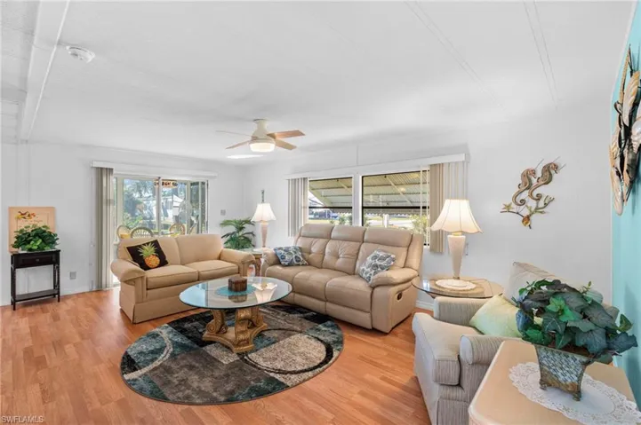 Living room with ceiling fan and light wood-type flooring