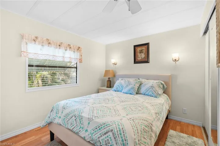 Bedroom featuring ceiling fan and hardwood / wood-style flooring