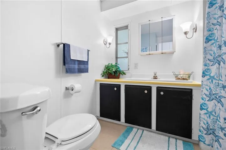 Bathroom with tile patterned flooring, vanity, and toilet