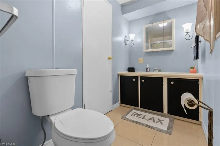 Bathroom with tile patterned floors, vanity, and toilet