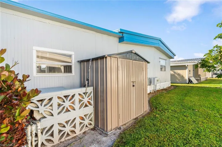 View of side of property with a yard
