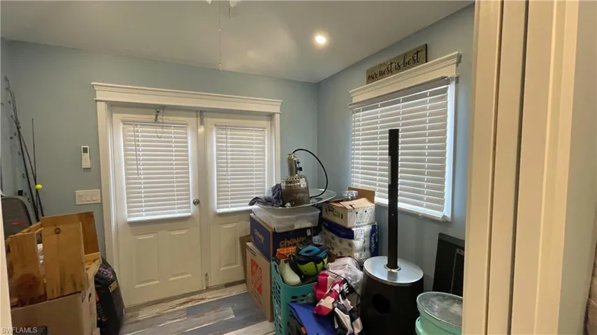 Laundry area featuring hardwood / wood-style flooring and plenty of natural light