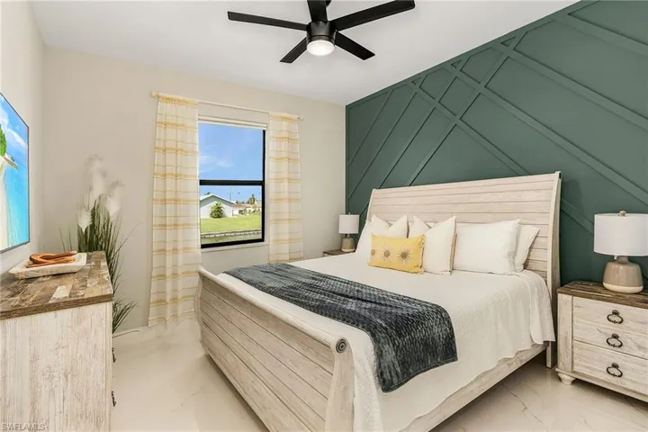 Bedroom 2 featuring marble finish floor and ceiling fan