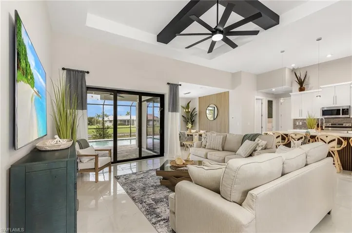 Living area featuring recessed lighting, ceiling fan, a high ceiling.