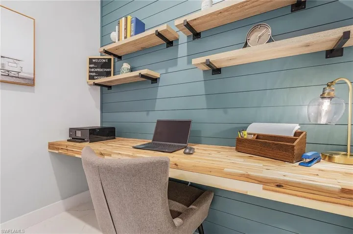 Office with baseboards and marble finish floor