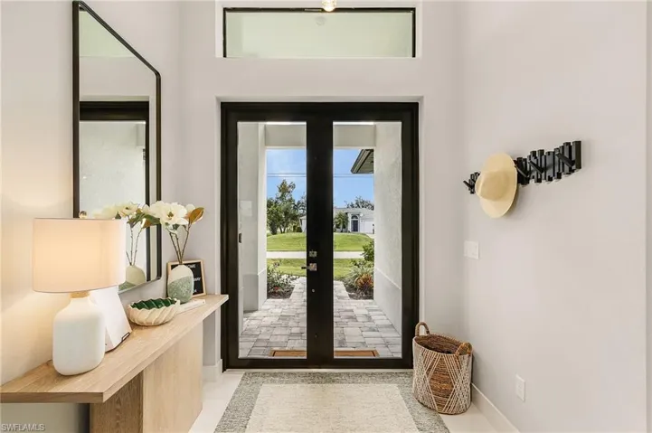 Doorway to outside featuring french doors and baseboards