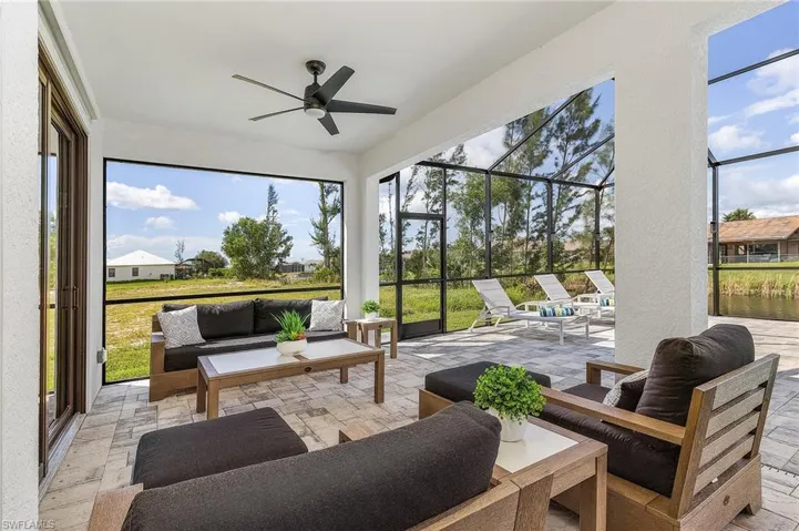Patio with an outdoor living space and ceiling fans.