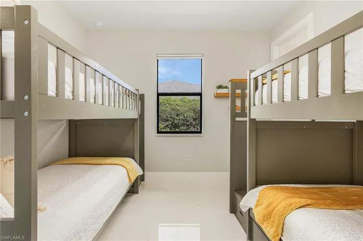 Bedroom 3 featuring baseboards and marble finish floor.