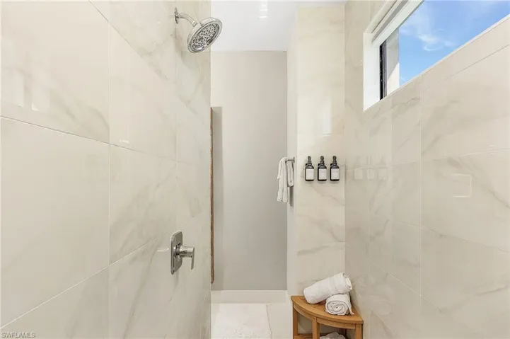 Bathroom with a tile shower.