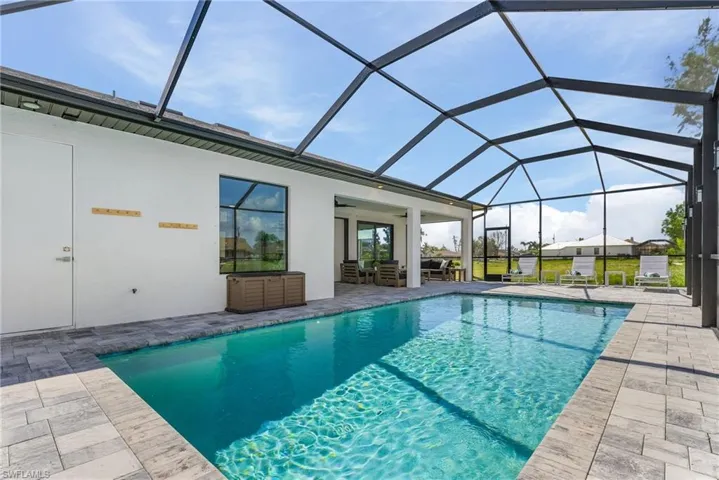 Outdoor pool with a ceiling fan, a lanai, a patio area, and outdoor lounge area