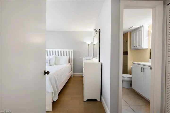 Bedroom featuring connected bathroom and light wood-style floors