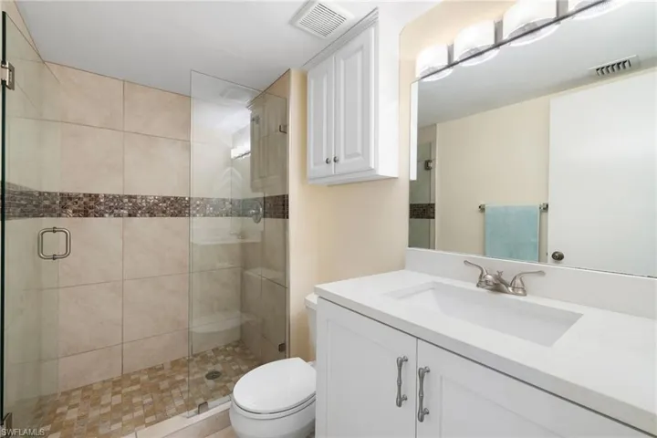 Full bathroom with a stall shower and vanity