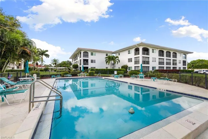 Community pool with a patio