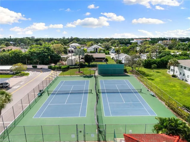 View of tennis court featuring a residential view