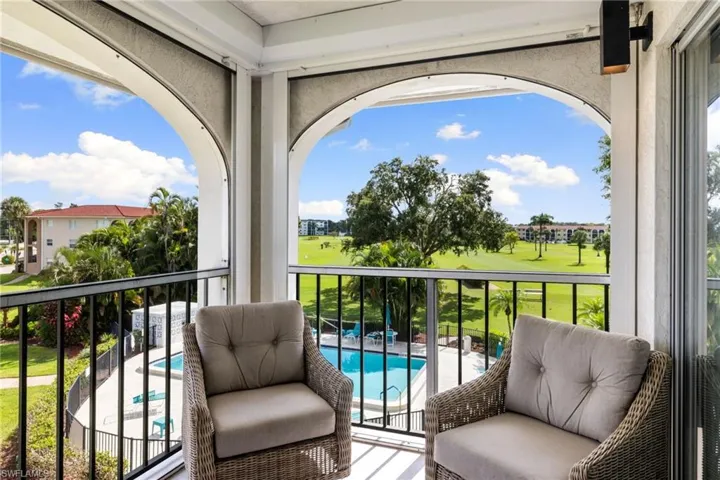 Balcony featuring view of pool area and golf course view
