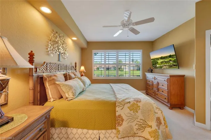 Bedroom with light carpet and ceiling fan