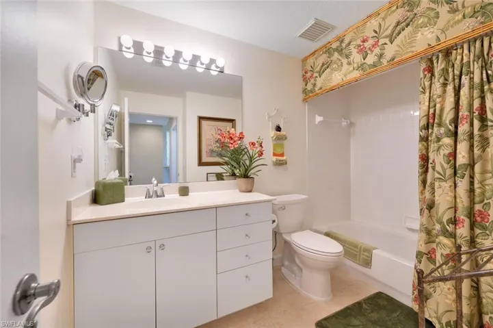 Full bathroom featuring tile flooring, vanity and shower / tub combo