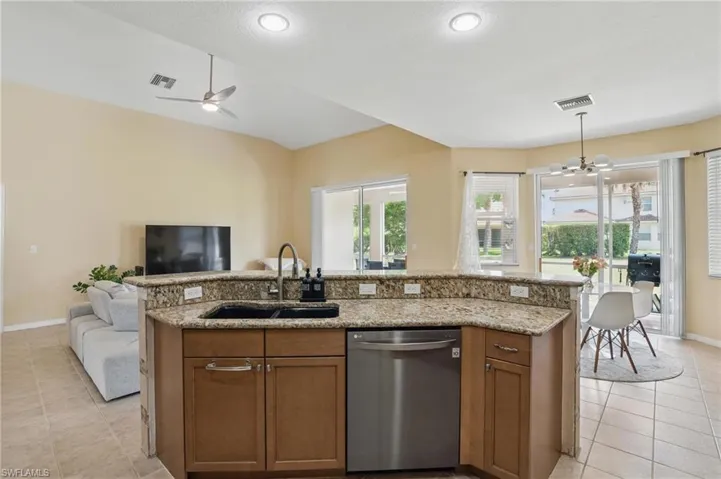 Kitchen featuring a sink, visible vents, open floor plan, light tile patterned floors, and stainless steel dishwasher