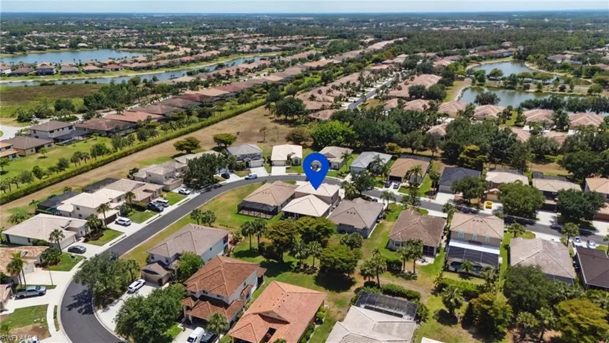 Birds eye view of property with a water view and a residential view