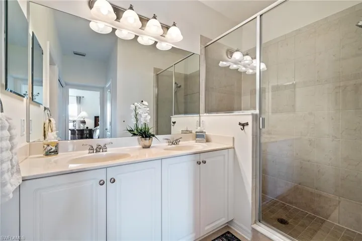 Bathroom featuring an enclosed shower and vanity