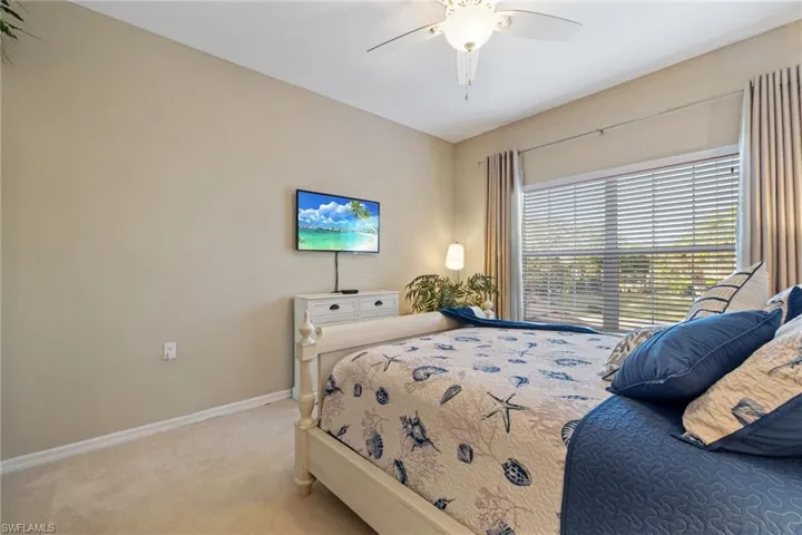 Bedroom with light carpet and ceiling fan