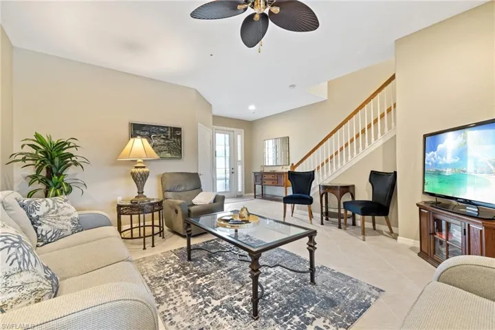 Tiled living room featuring ceiling fan