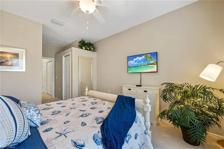Carpeted bedroom with ceiling fan