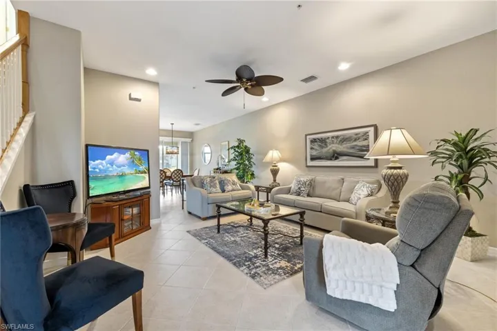 Tiled living room featuring ceiling fan