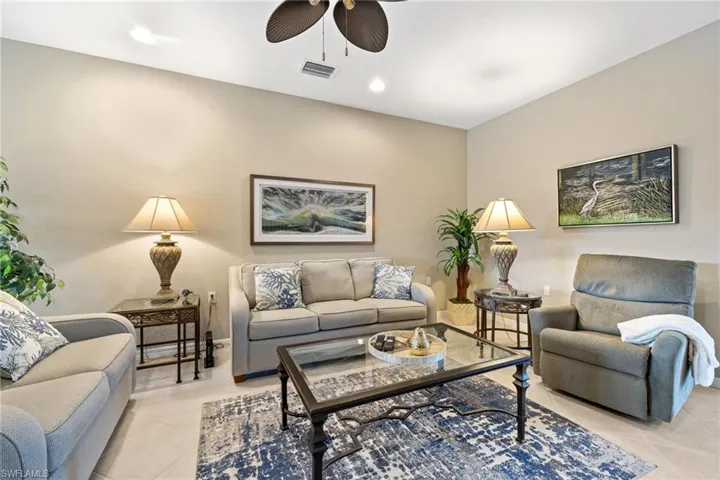 Living room featuring ceiling fan and light tile patterned floors