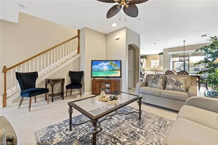 Tiled living room featuring ceiling fan