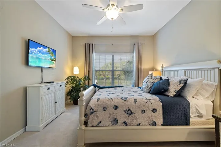 Bedroom featuring ceiling fan and light carpet