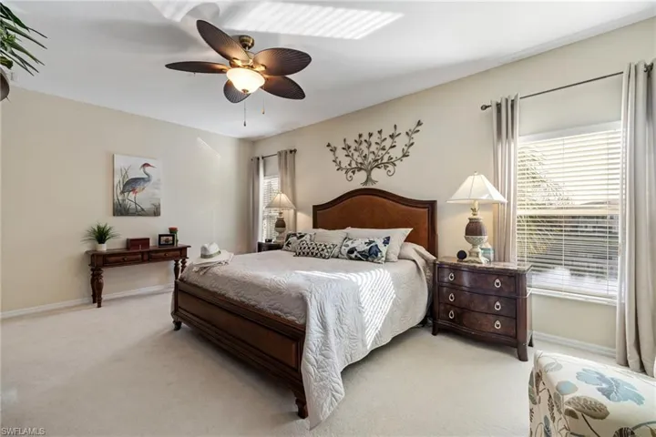 Main Bedroom featuring light colored carpet and ceiling fan