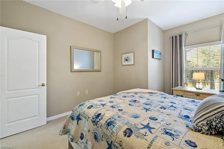 Bedroom featuring light carpet and ceiling fan