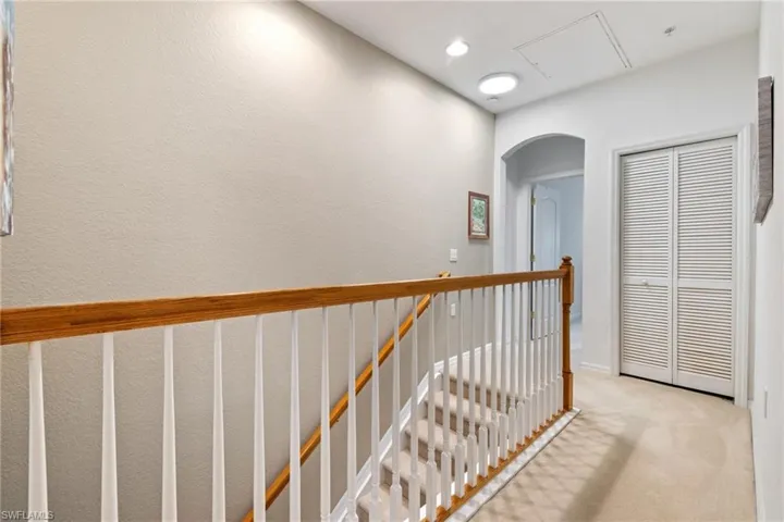 Hall with light colored carpet