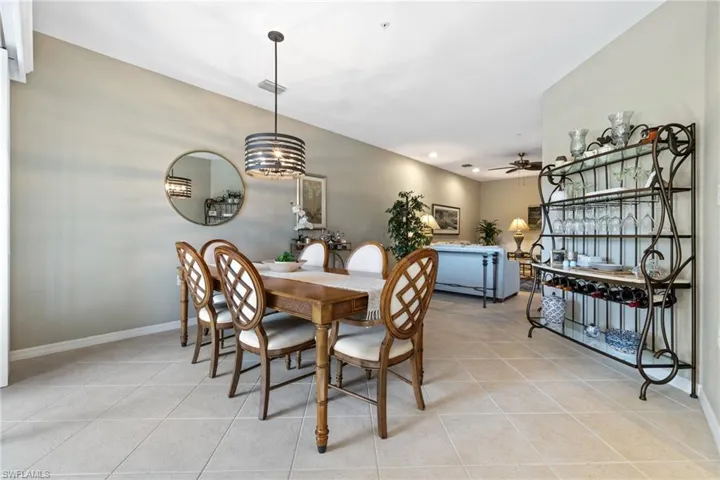 Tiled dining room with ceiling fan