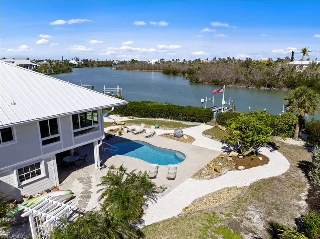View of swimming pool with a patio and a water view