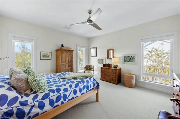 Bedroom featuring access to exterior, ceiling fan, and carpet