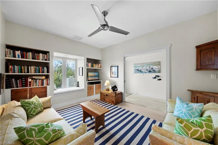 Sitting room with light hardwood / wood-style floors and ceiling fan