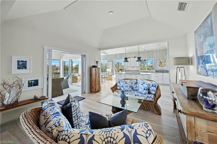 Living room featuring high vaulted ceiling and light hardwood / wood-style floors