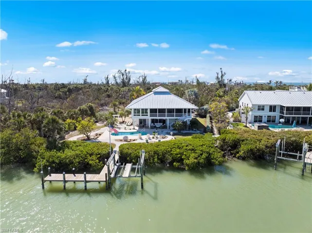 Back of house featuring a water view and a sunroom