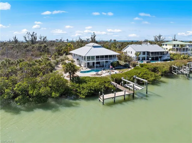 Rear view of property with a swimming pool and a water view