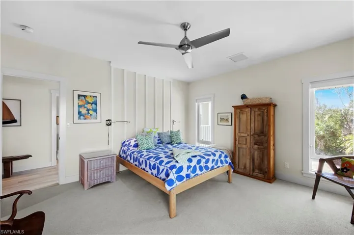 Bedroom featuring ceiling fan and light colored carpet