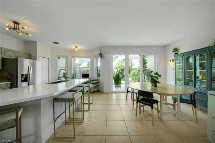 Dining room with sink and light tile floors