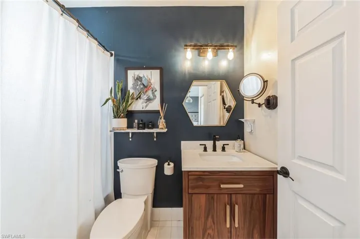 Bathroom featuring tile flooring, toilet, and vanity