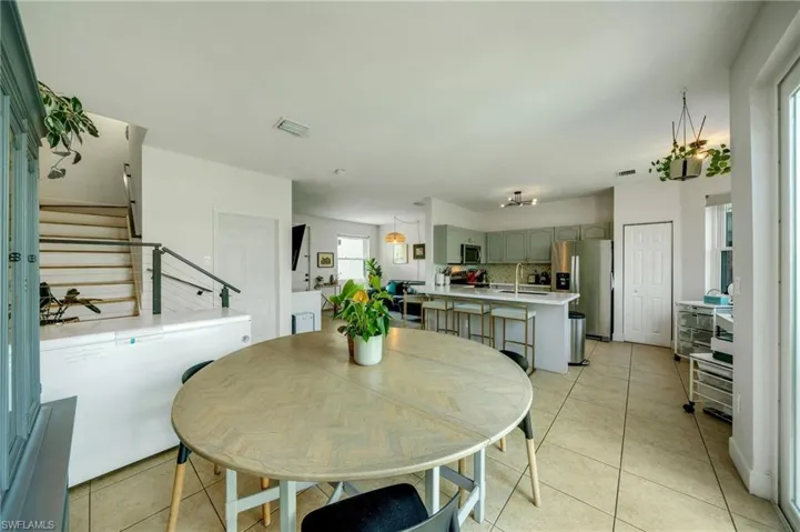 Dining area with sink and light tile floors