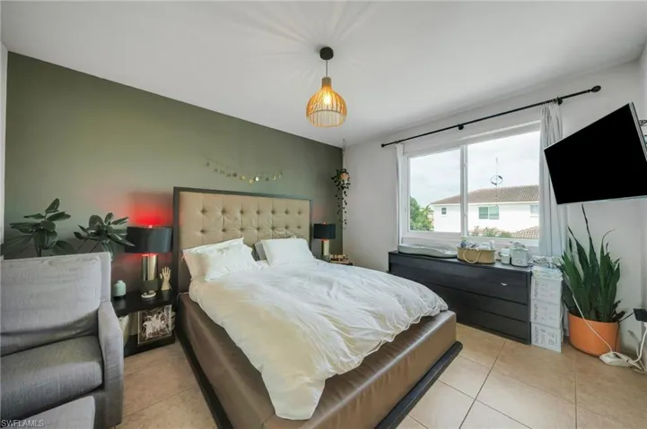 Bedroom featuring light tile floors
