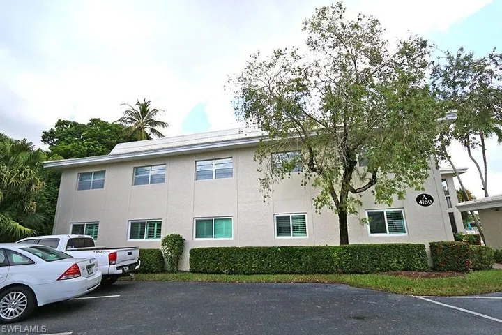 View of property with uncovered parking